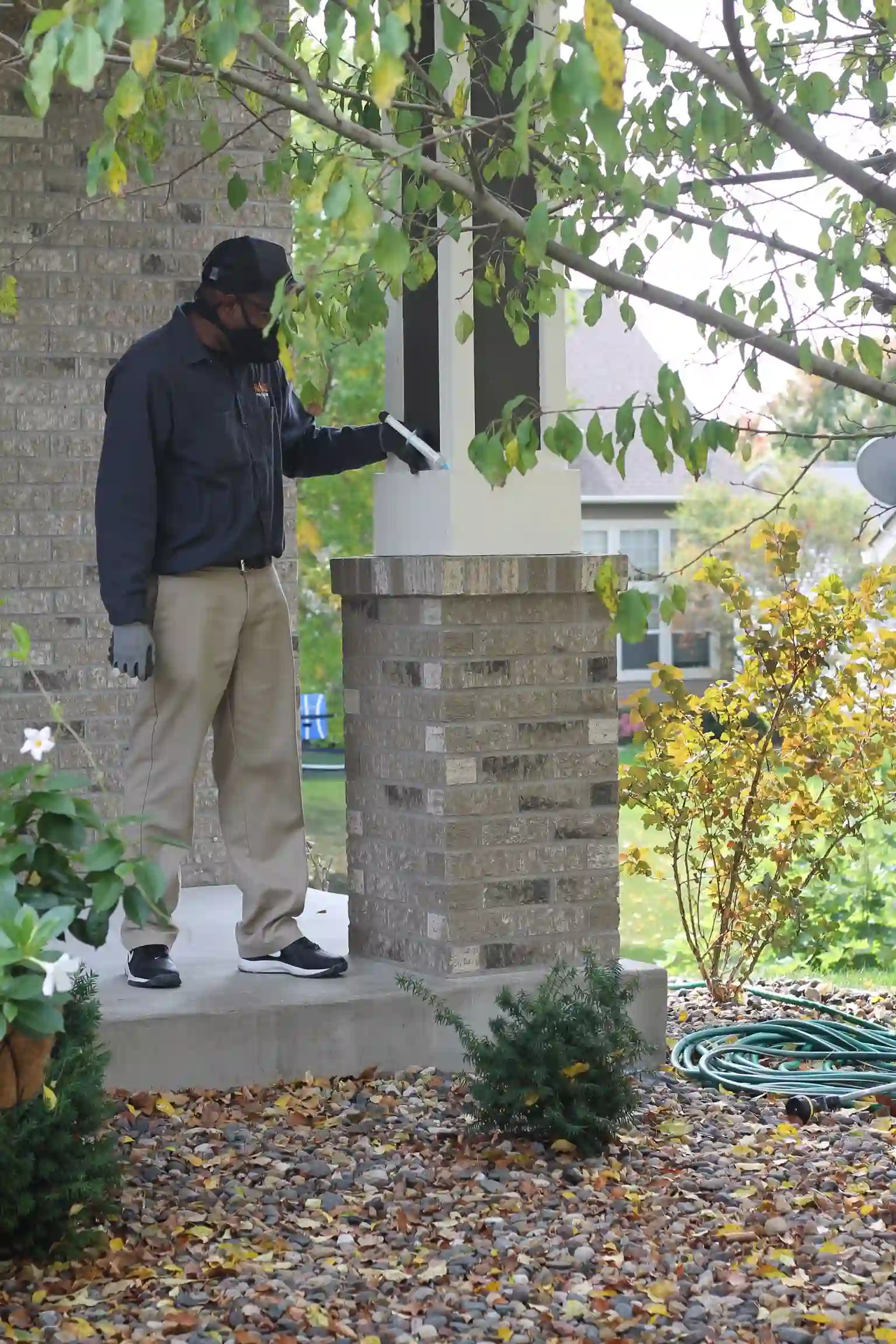 Rove Pest Control exterminator applying treatment outside