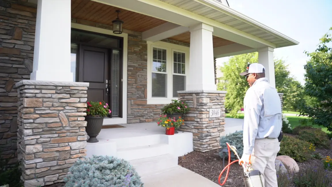 Home Technician for Pest Control Standing outside front porch